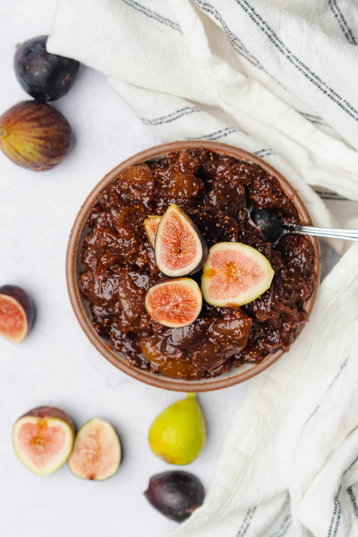 flat lay of bowl full of fig spread topped with lovely fresh figs