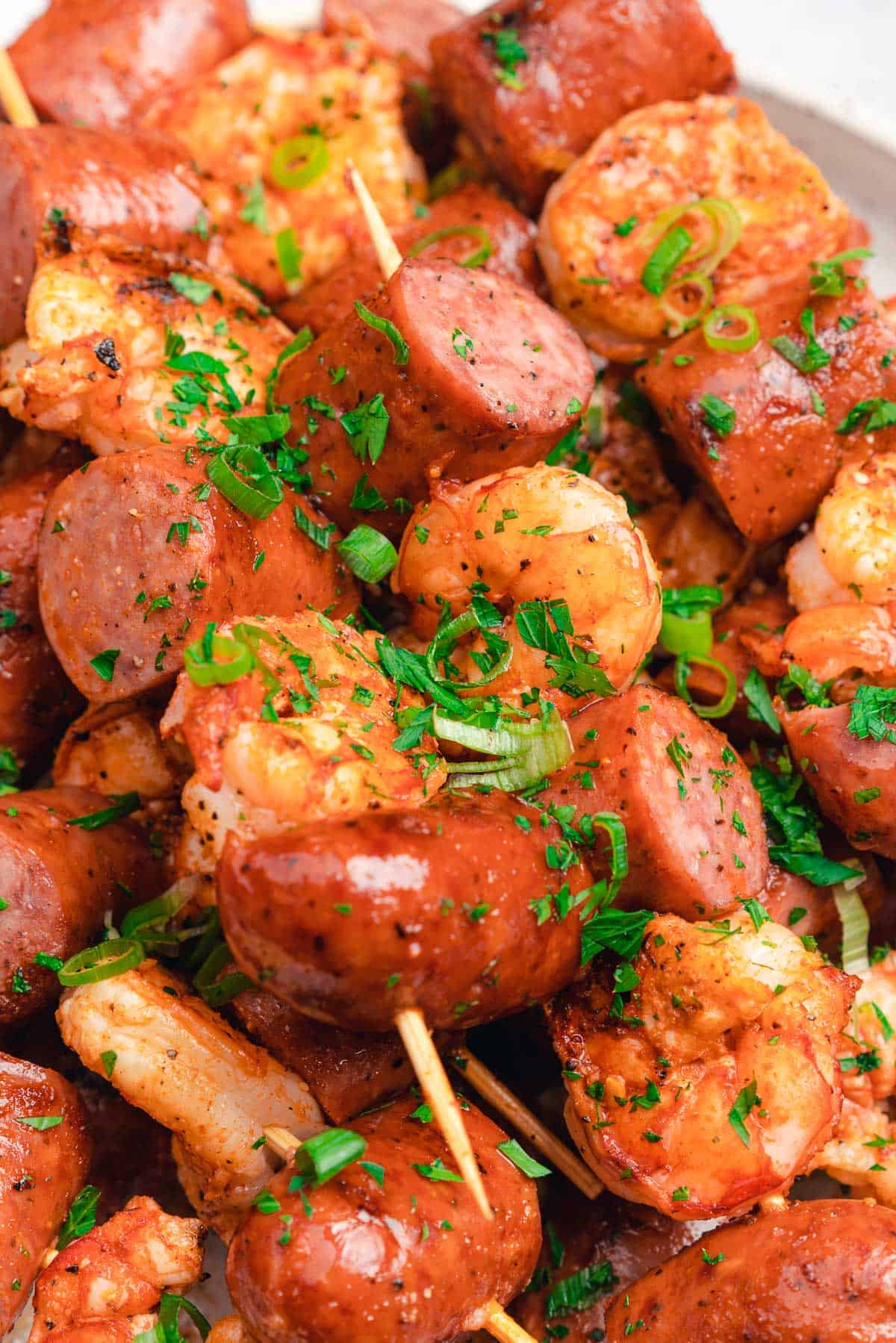 grilled smoked sausage and shrimp skewers with parsley and green onions 