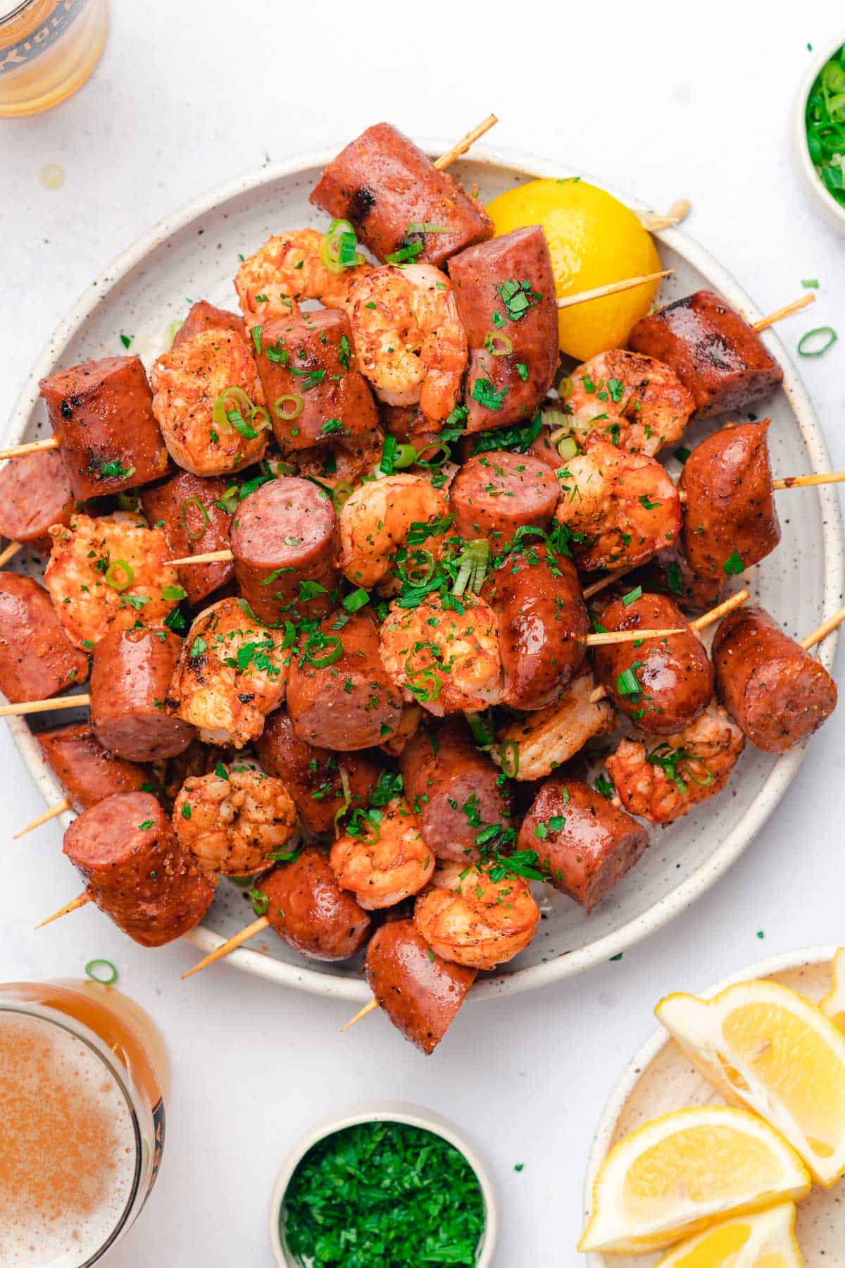 flat lay close up of grilled smoked sausage and shrimp skewers
