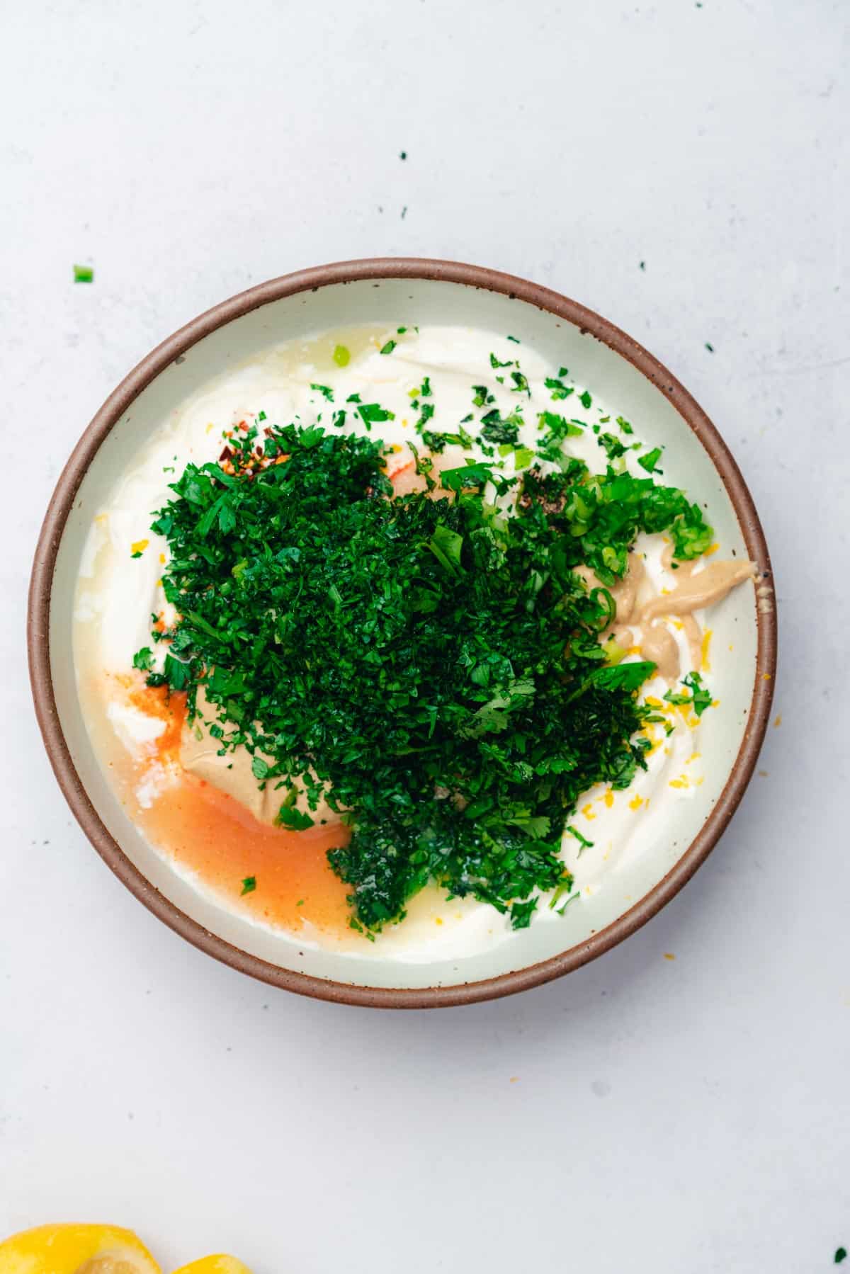 sour cream with lots of seasonings and fresh green herbs