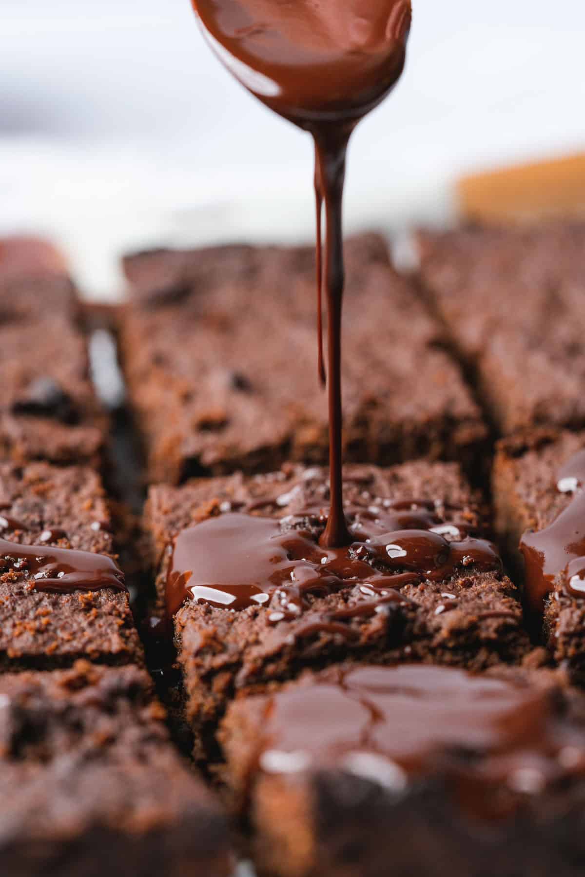 close up shot of a brownie being drizzled with chocolate