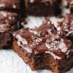 Healthy pumpkin brownies with a rich chocolate ganache topped with flakey sea salt and a bite taken out