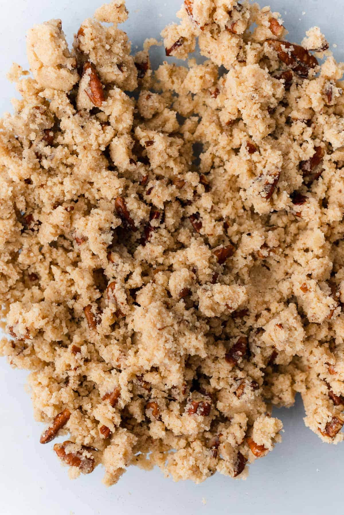 shortbread crumble topping with pecans in a glass bowl
