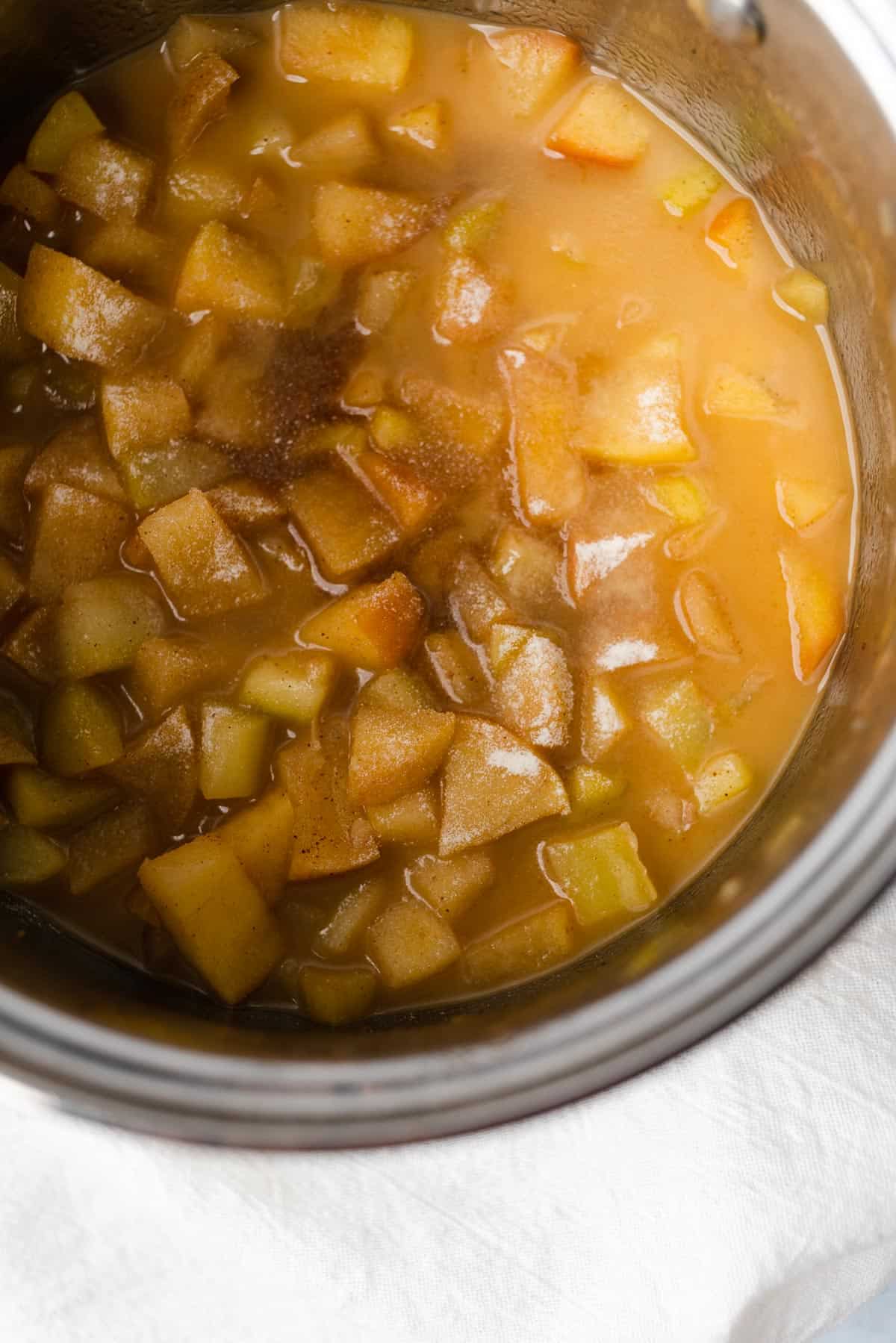 apples and zucchini simmering in a buttery spiced sauce