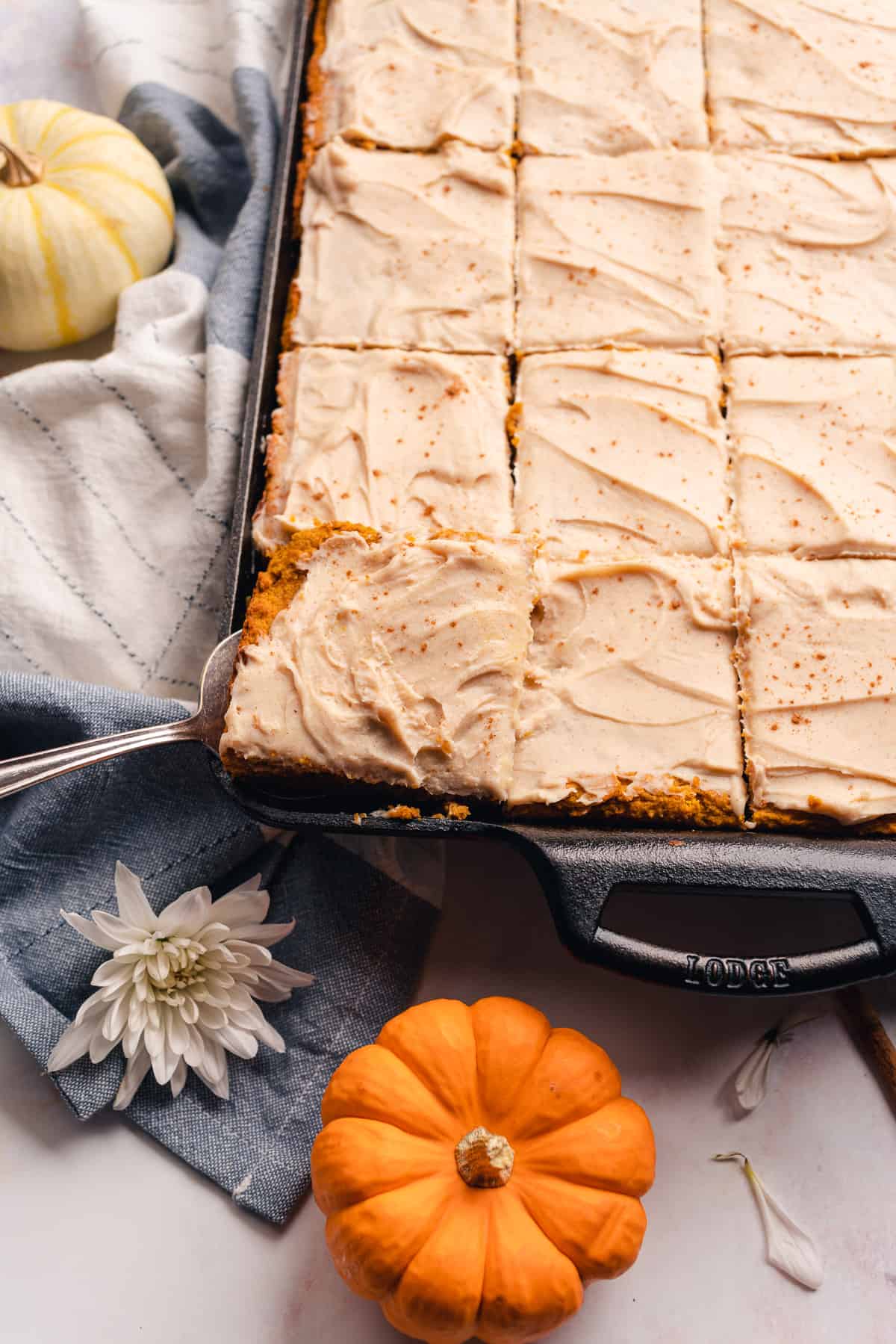 Shot of a lodge cast iron baking pan with a slice of keto pumpkin bar being removed from the pan