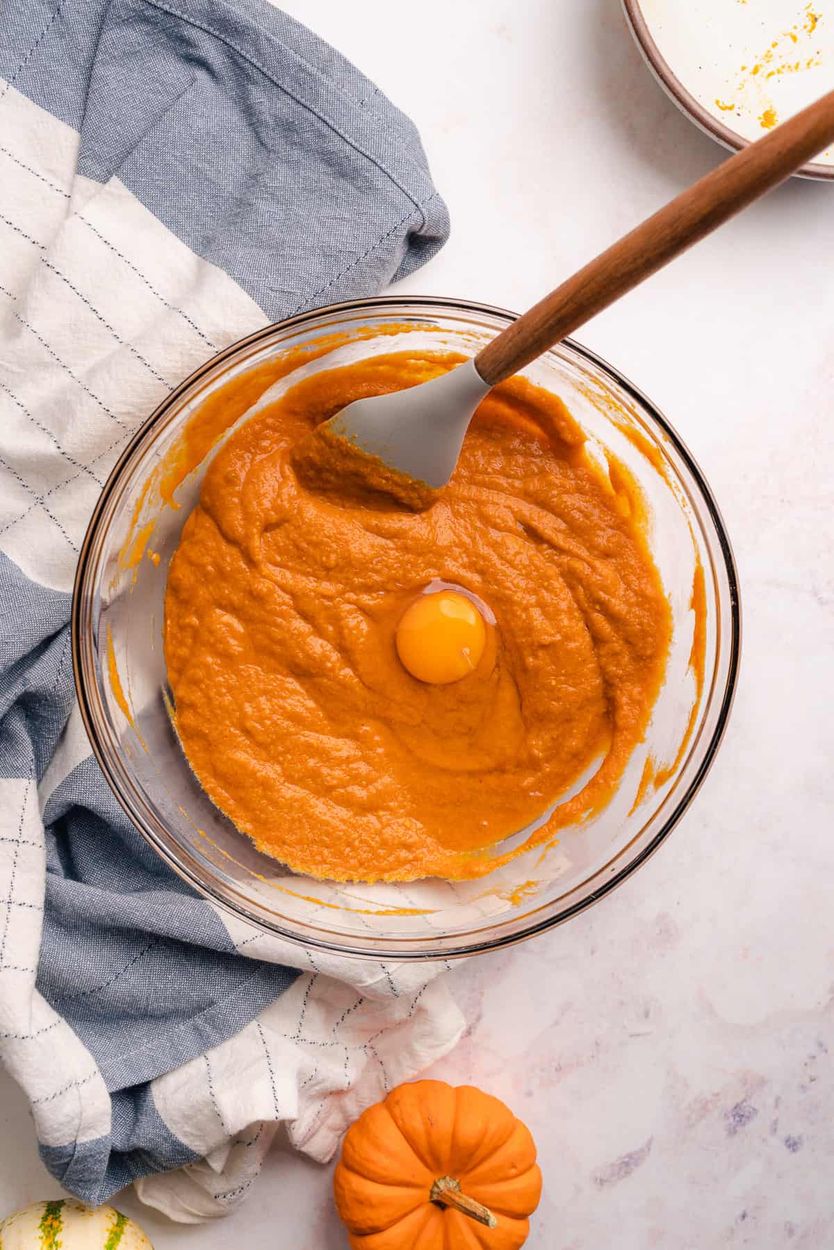 eggs in mixing bowl with pumpkin puree batter