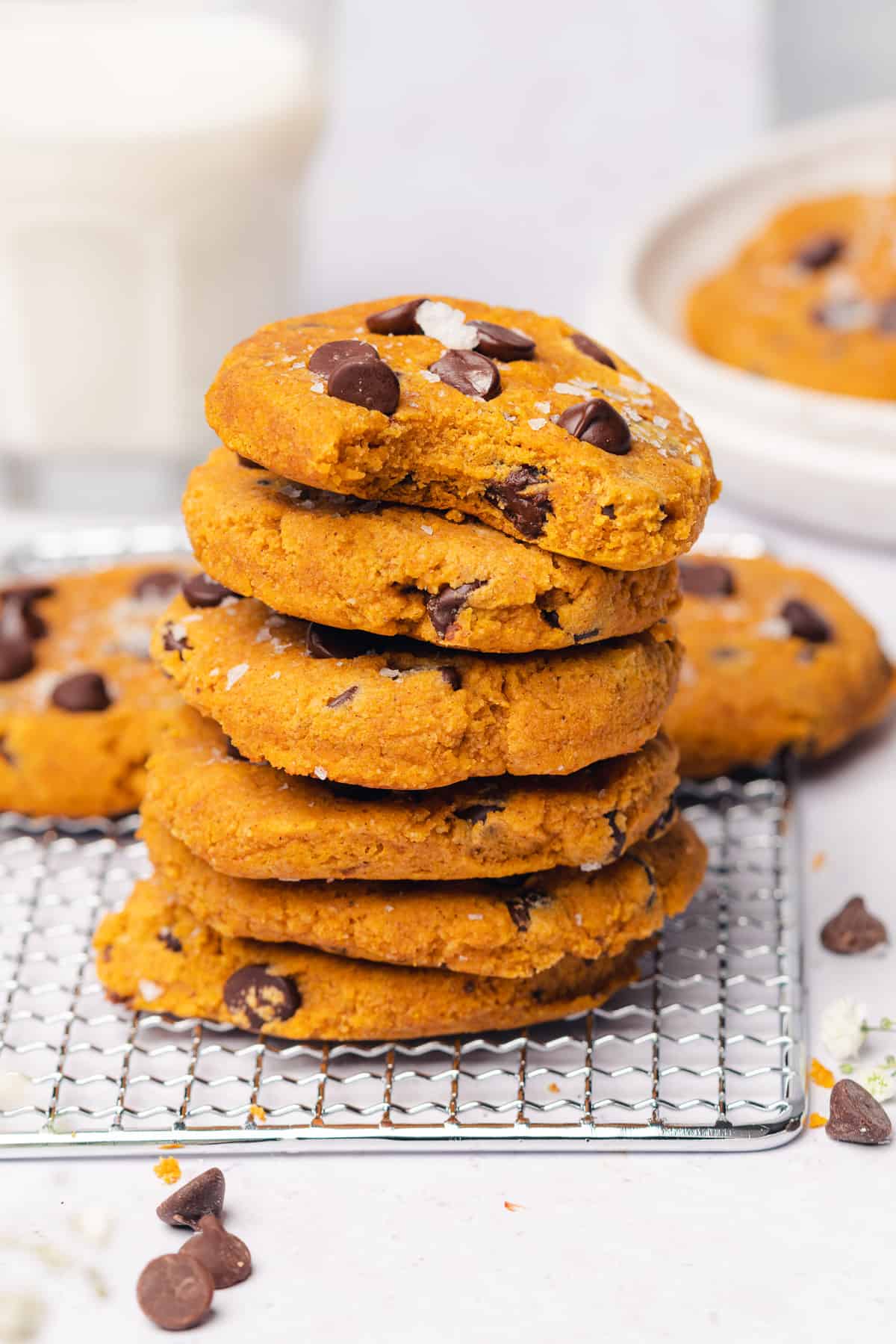 close up stack shot of keto pumpkin chocolate chip cookies with a bite taken out of the top cookie