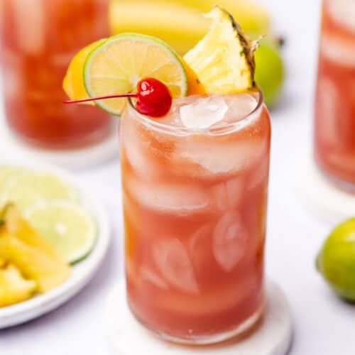 bright and colorful sugar free rum runner recipe with orange, lime and pineapple