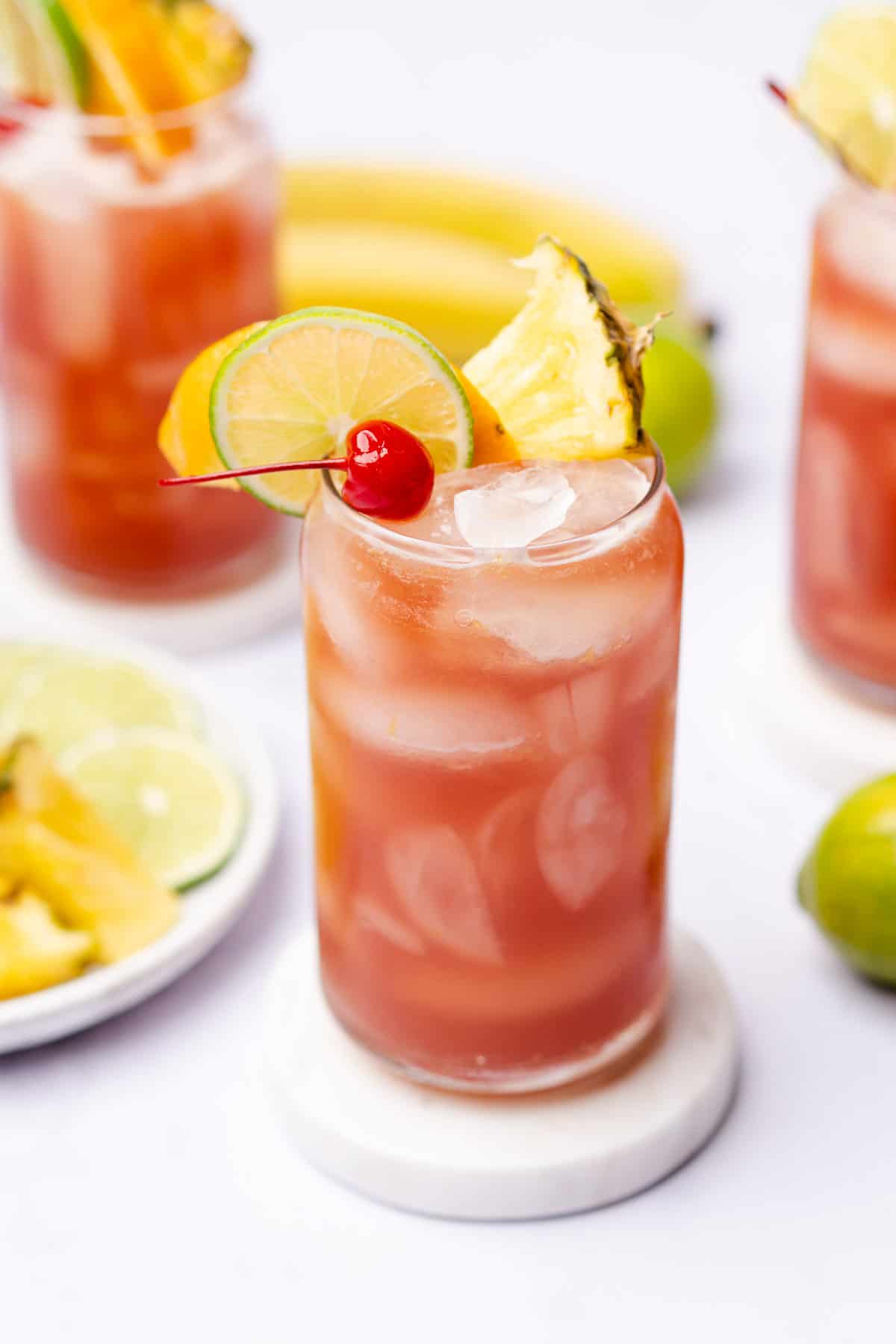 bright and colorful sugar free rum runner recipe with orange, lime and pineapple