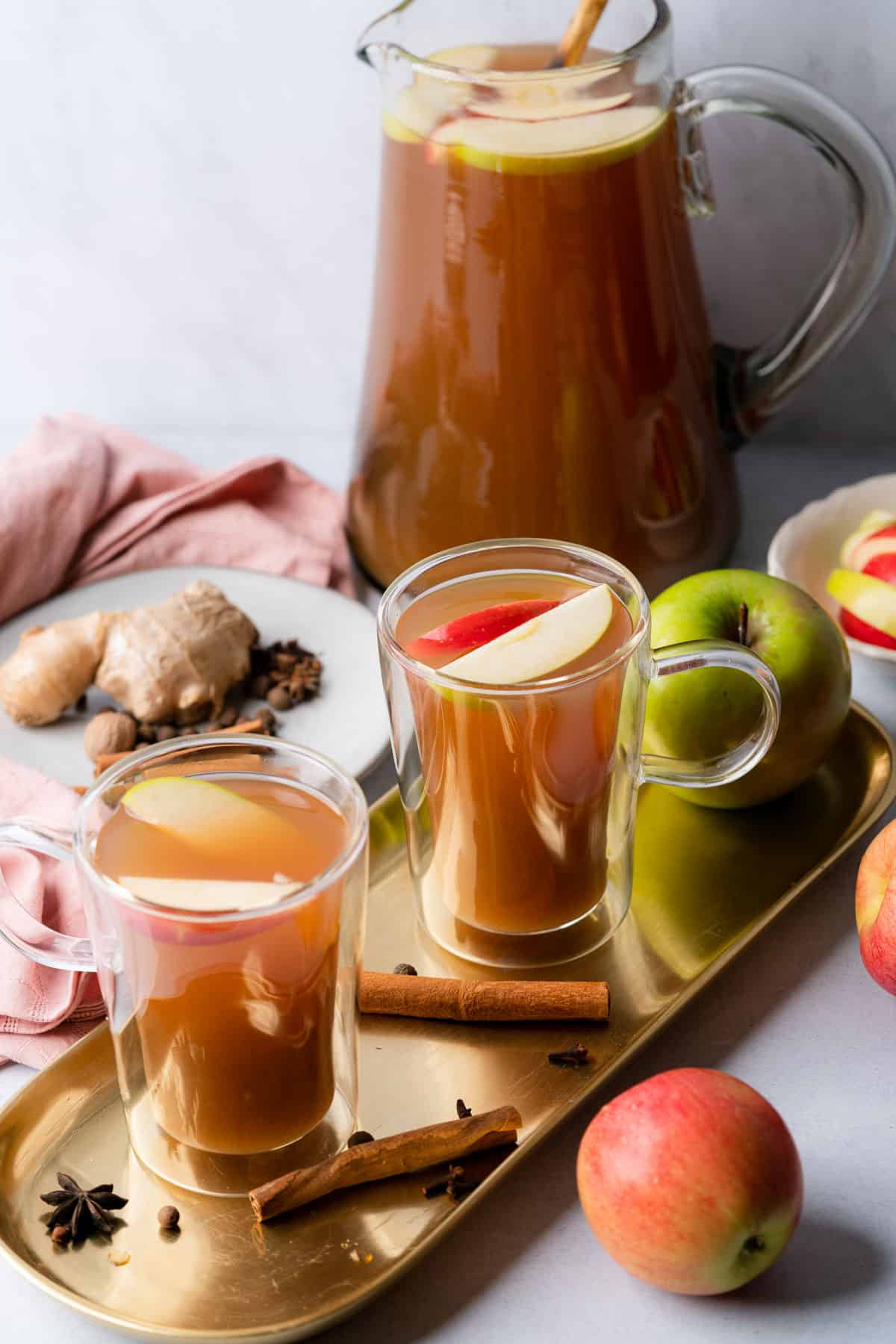 sugar free apple cider with a jar of apple cider in the background and fresh apples and spices