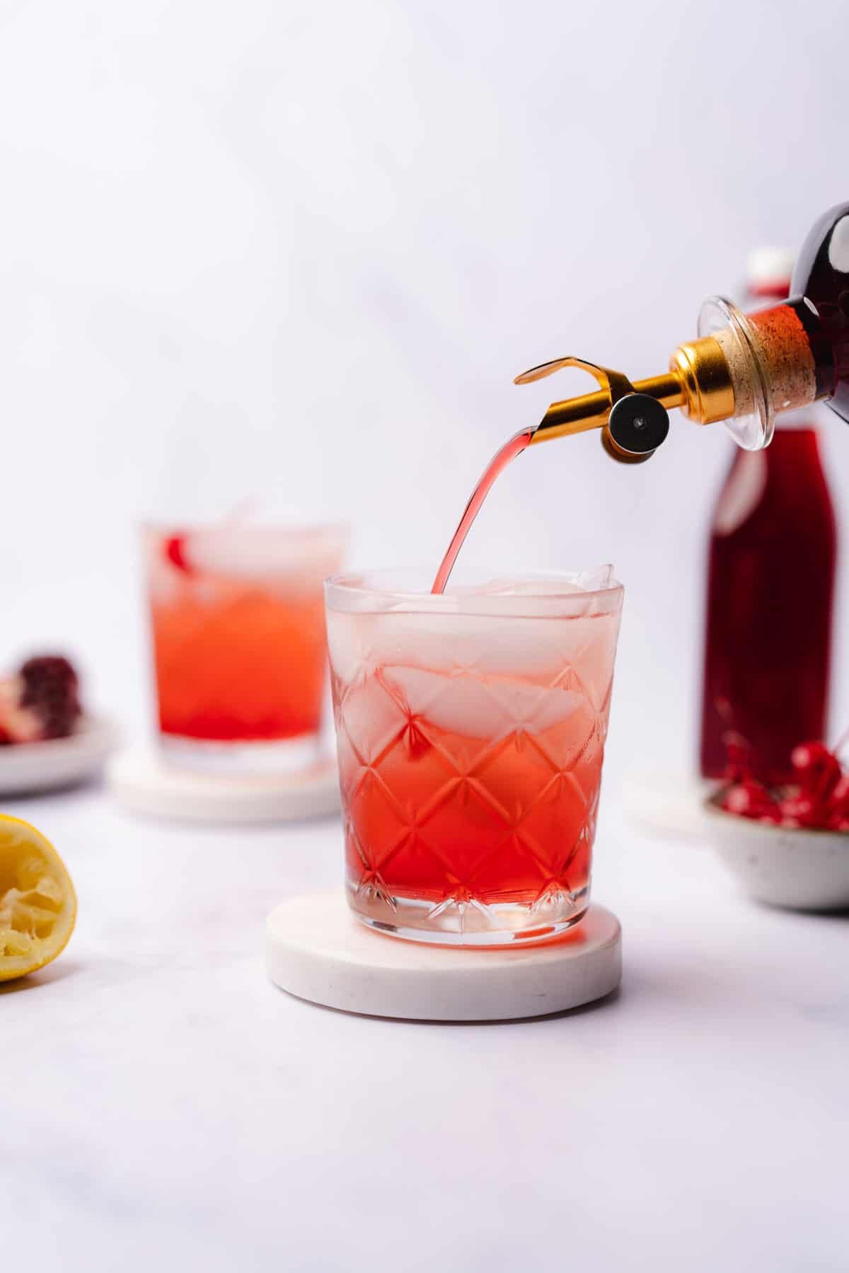 pouring sugar free grenadine into a shirley temple mocktail