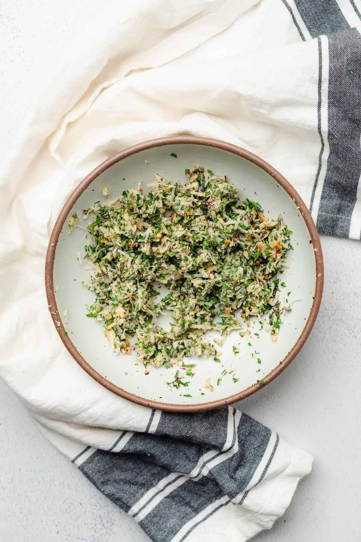 ceramic bowl with a parmesan cheese, garlic butter herb mixture