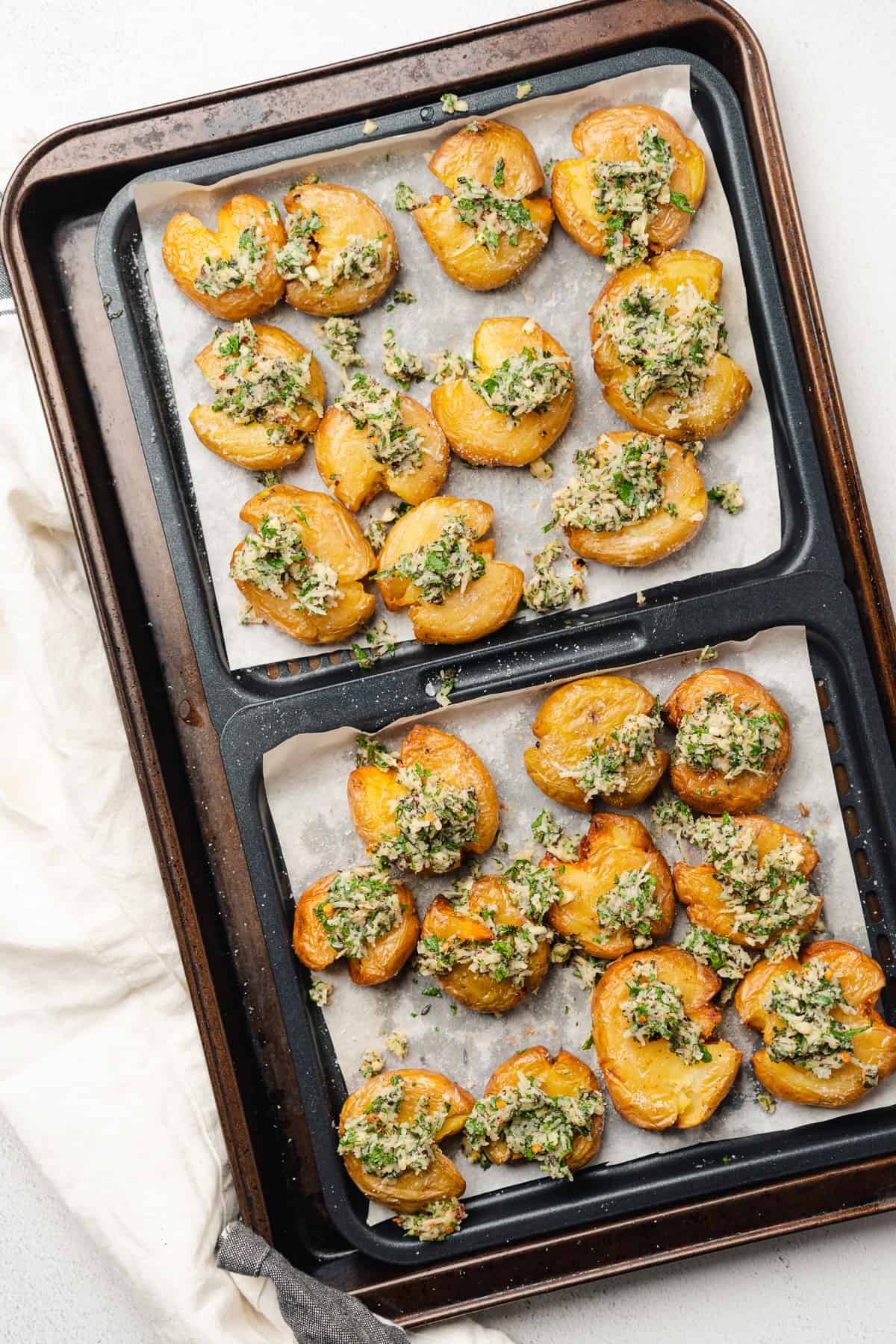 crispy air fryer smashed potatoes topped with herbs and garlic 