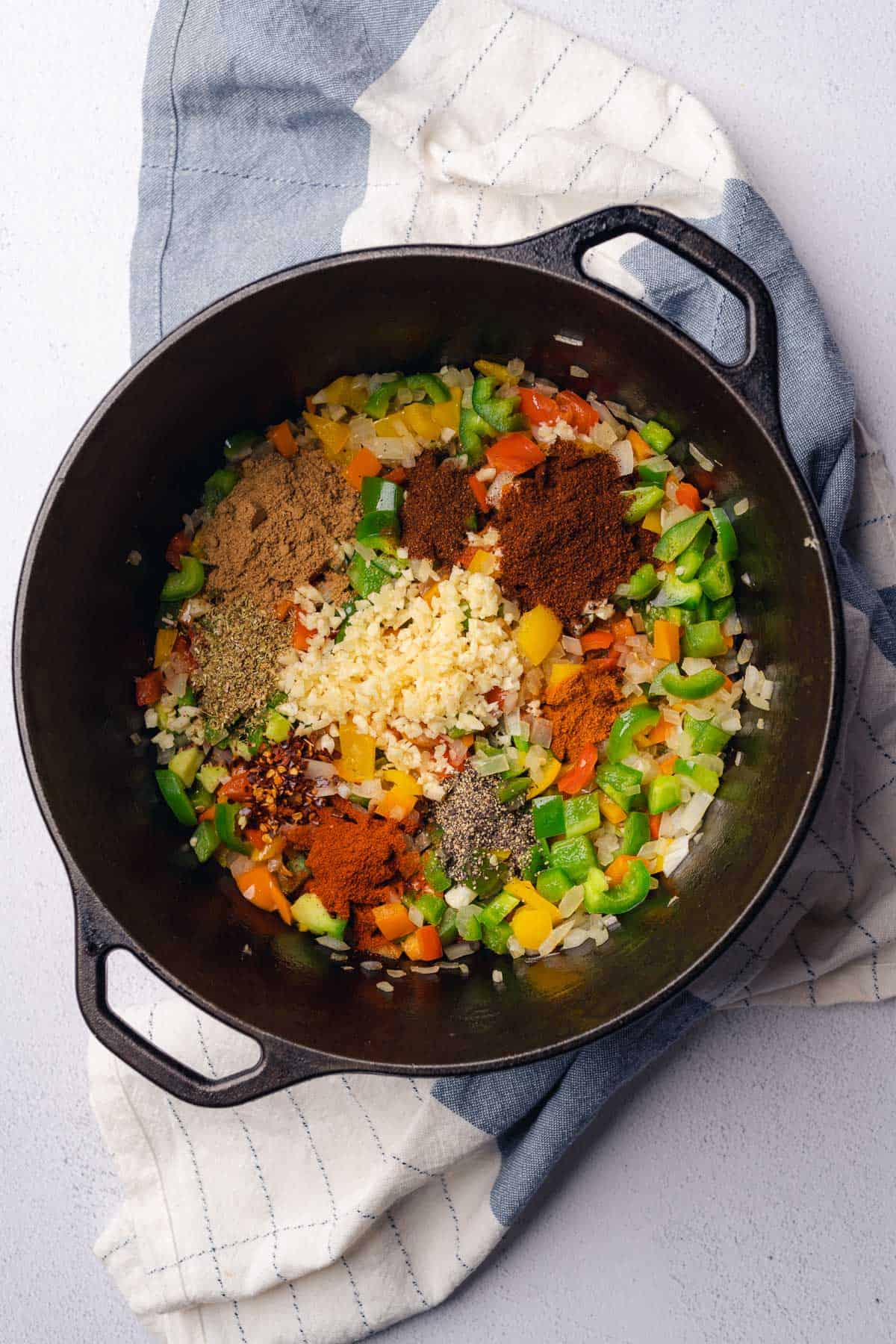 bell peppers, onions, garlic, and dried seasonings in a cast iron dutch oven