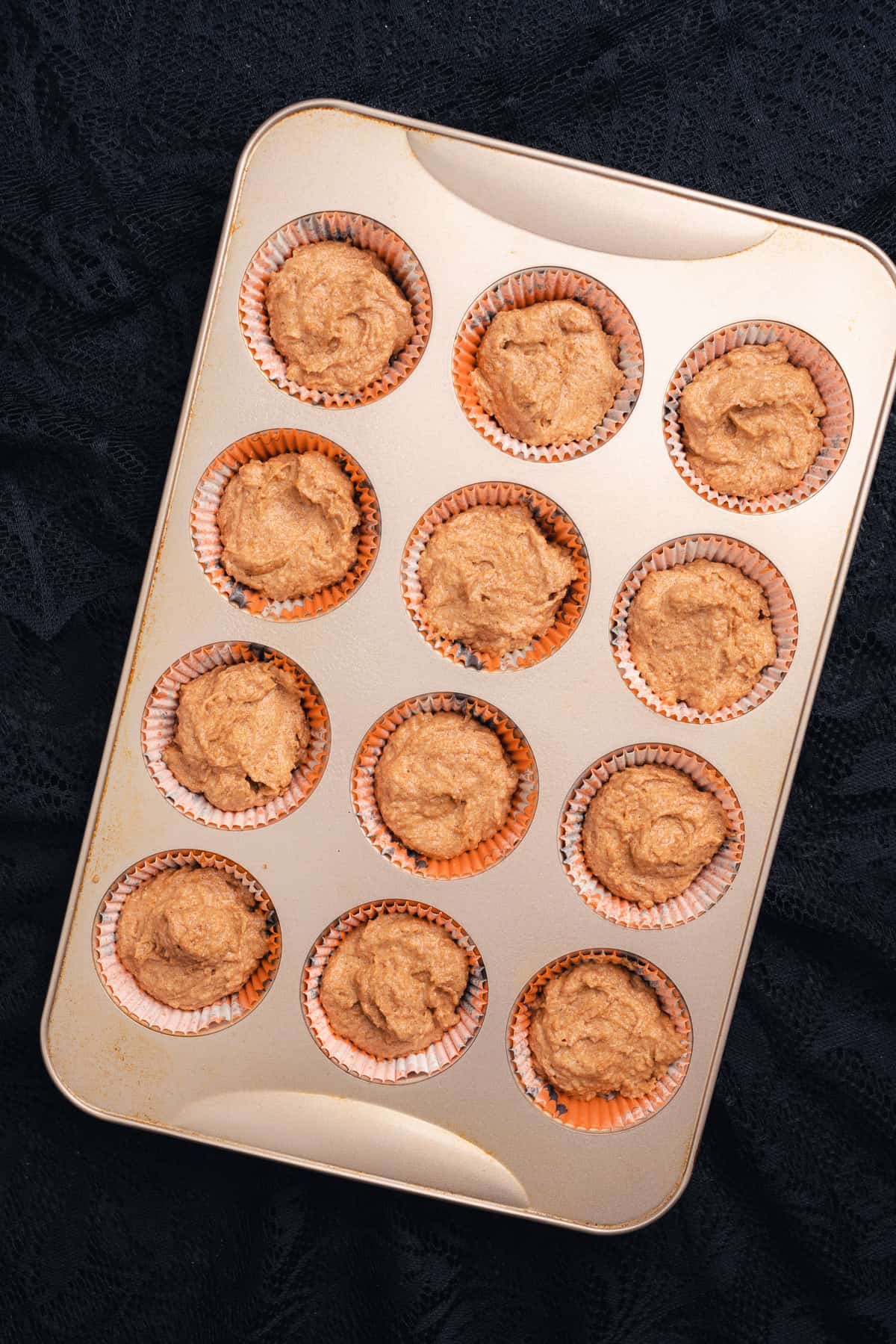 cupcake batter in a muffin tin 