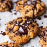 big keto peanut butter chocolate chip cookies with chocolate drizzle and sea salt