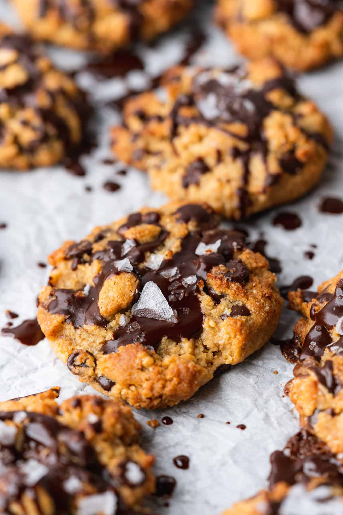 big keto peanut butter chocolate chip cookies with chocolate drizzle and sea salt