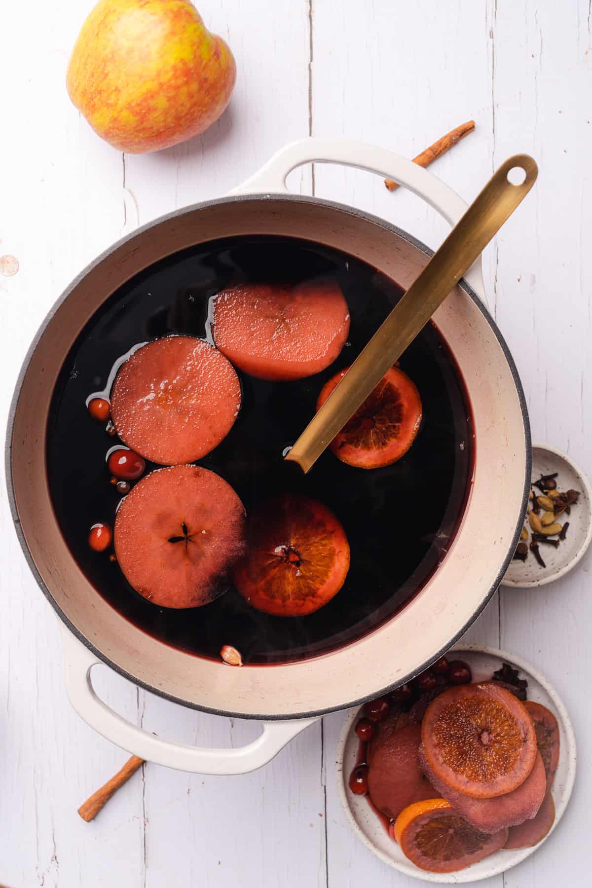 straining fruit and spices from mulled wine 