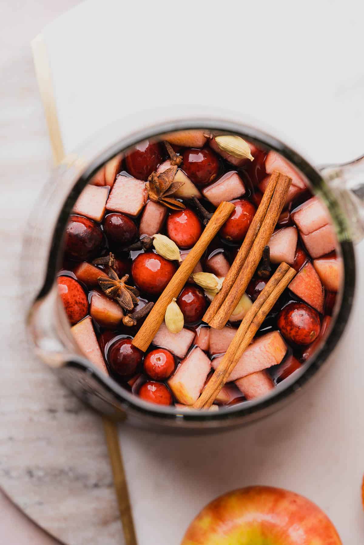 flat lay of bourbon whiskey sangria with warming spices and fruit on top of the pitcher