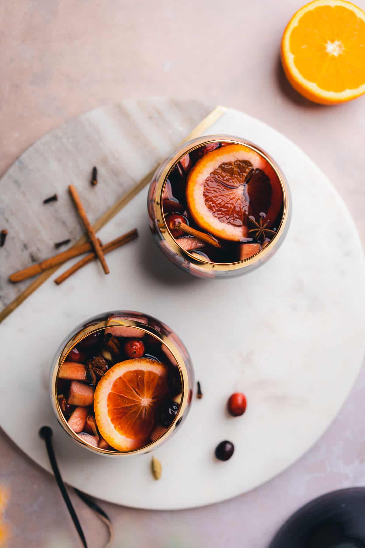 flat lay shot of two goblet style glasses full of bourbon whiskey sangria