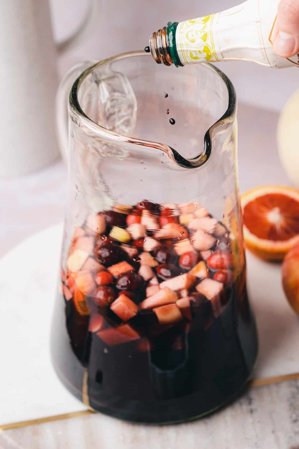 cardamom bitter being poured into a large pitcher