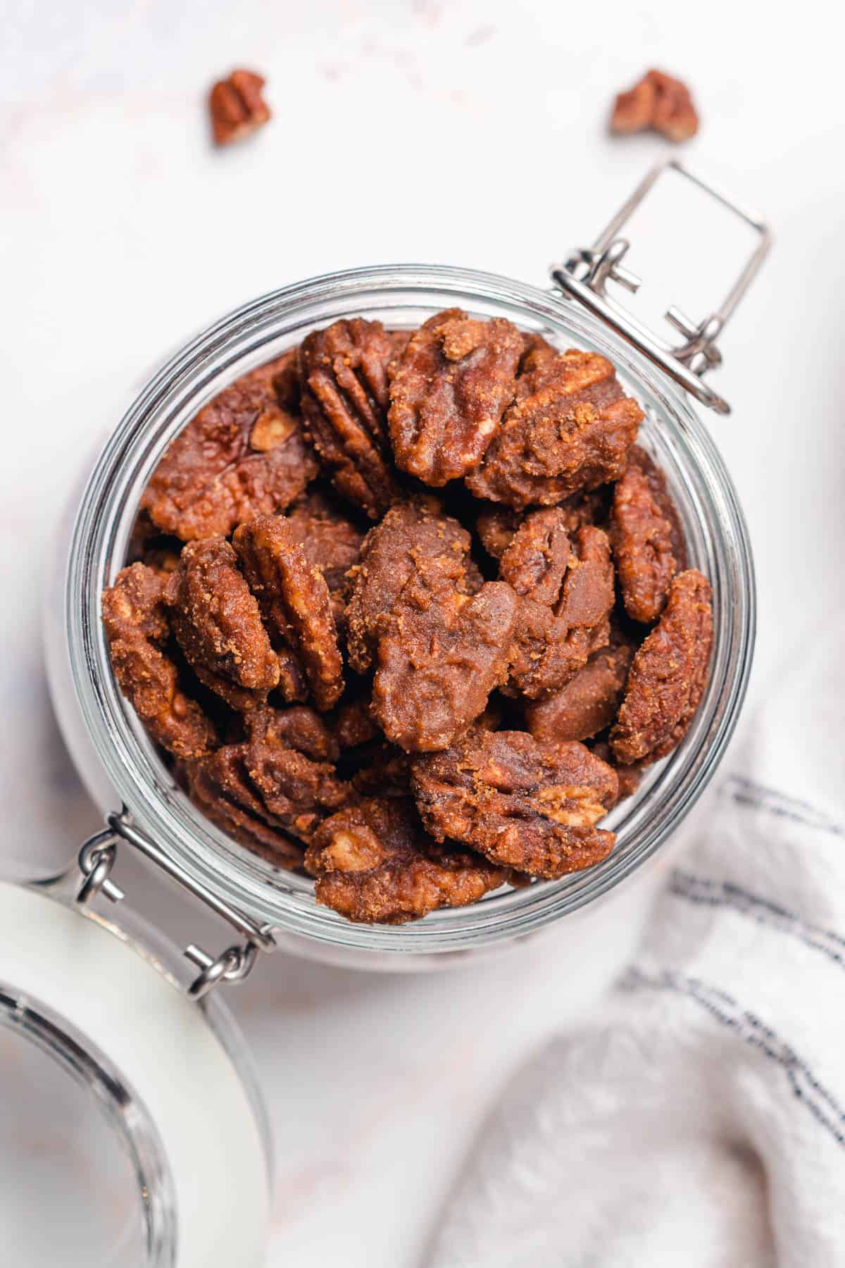 glass jar full of keto candied pecans