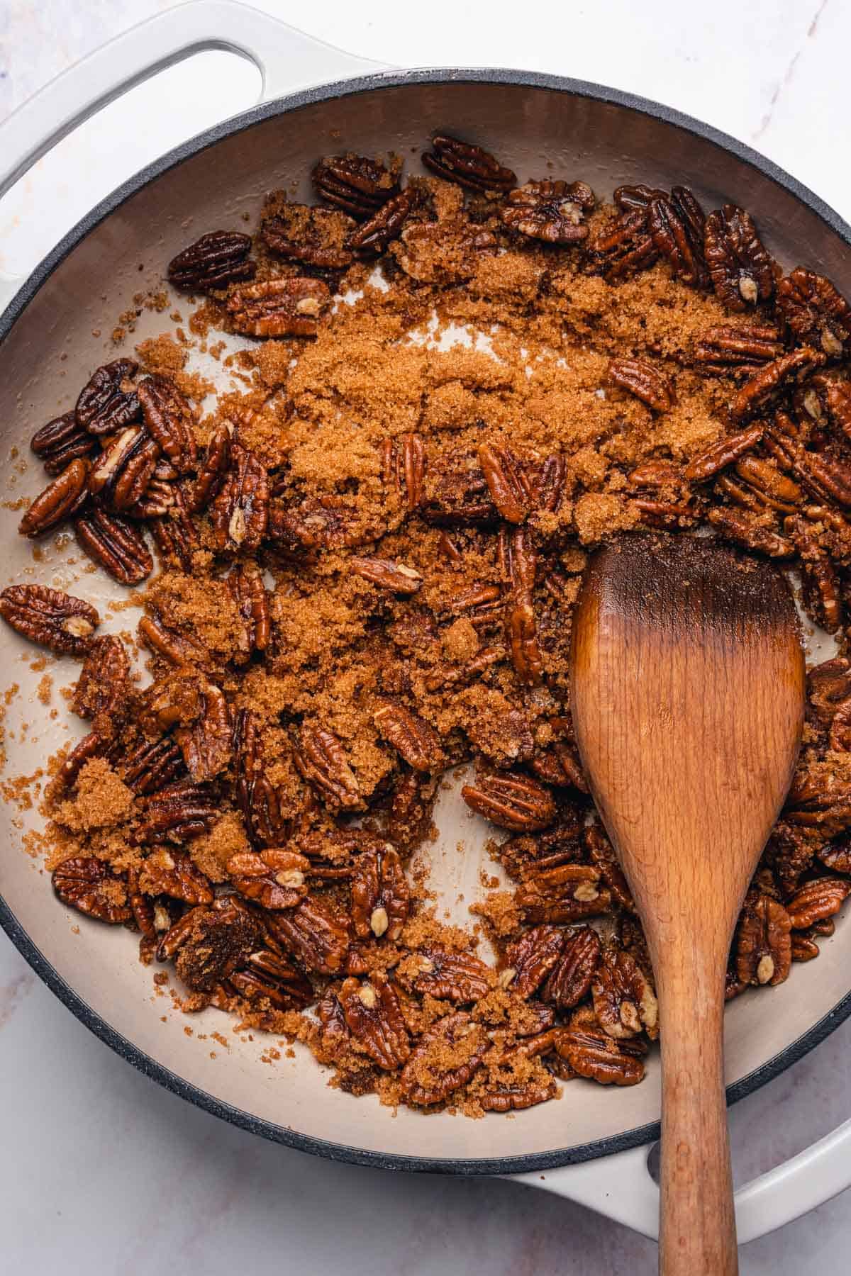 pecans in an enameled cast iron with sweetener and cinnamon