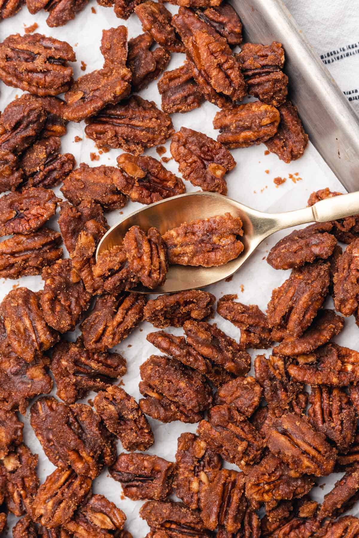 keto candied pecans on a baking sheet with parchment paper 
