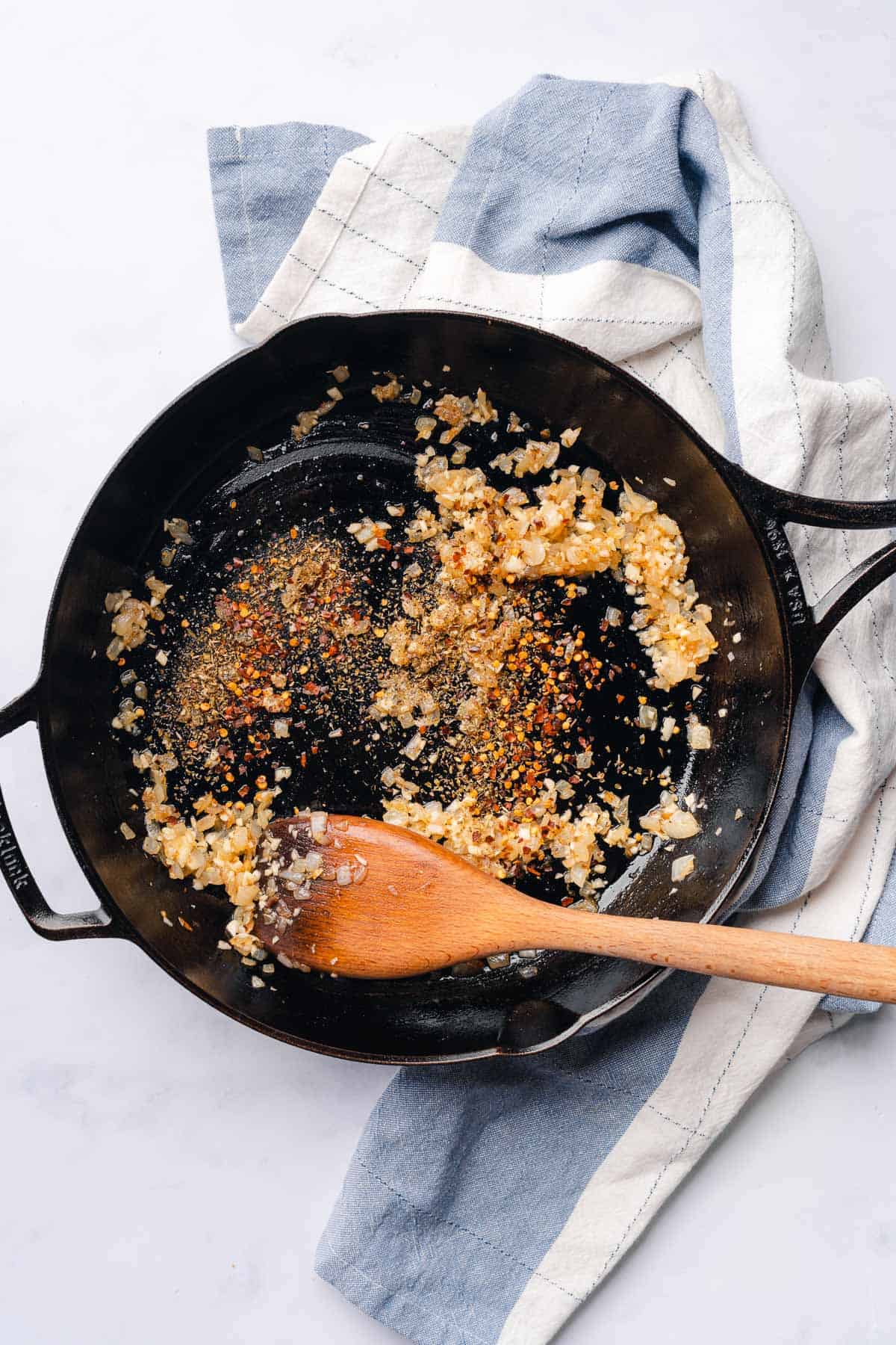 cooked onions and garlic in a cast iron skillet, with oregano, red pepper flakes and black pepper added