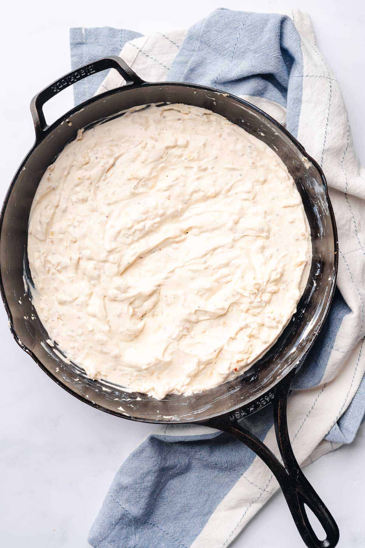 softened cream cheese and sour cream in a cast iron skillet