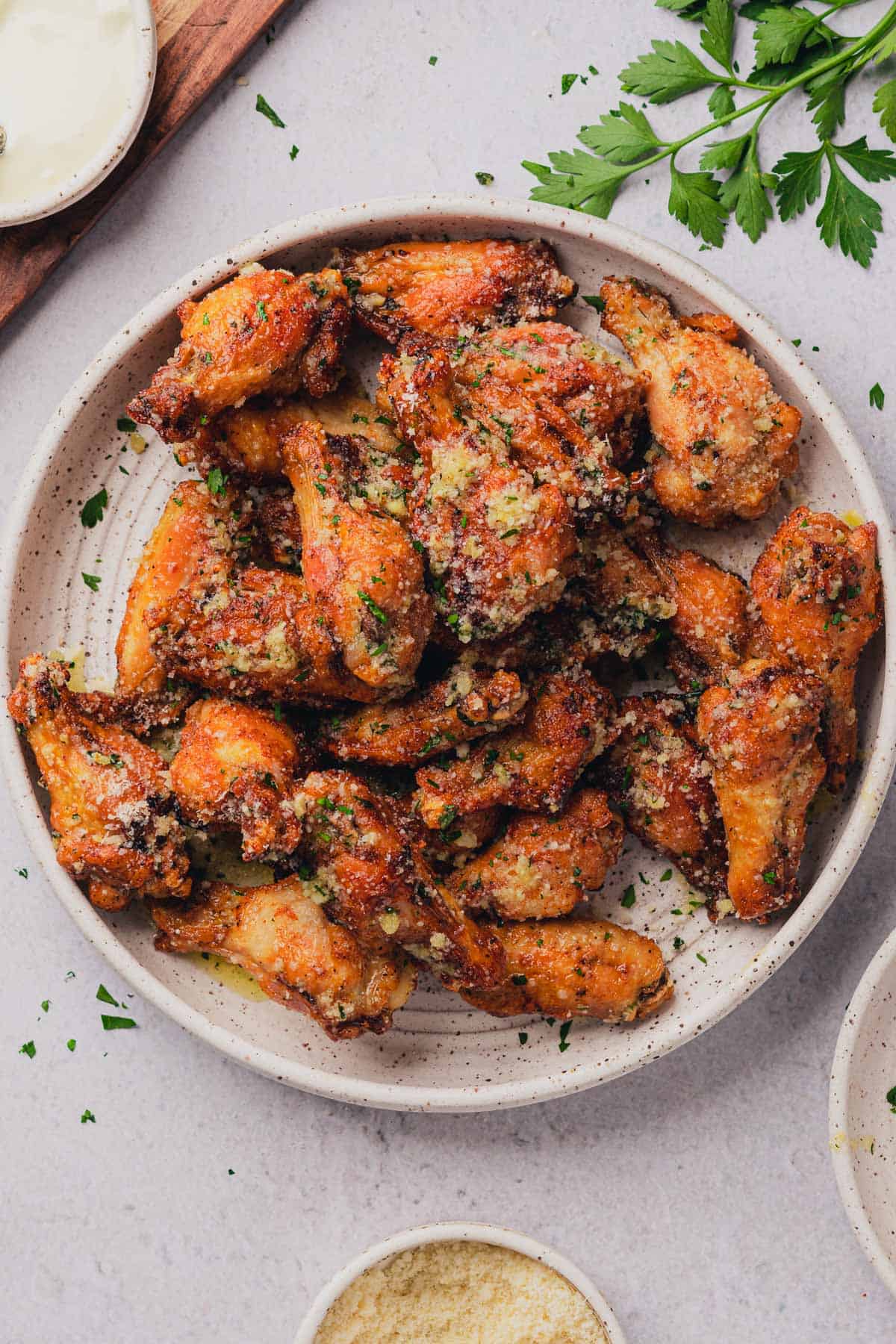 air fryer garlic parmesan wings on a white plate.