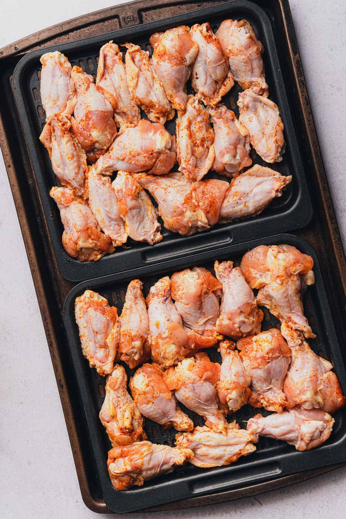 raw chicken wings on air fryer trays 