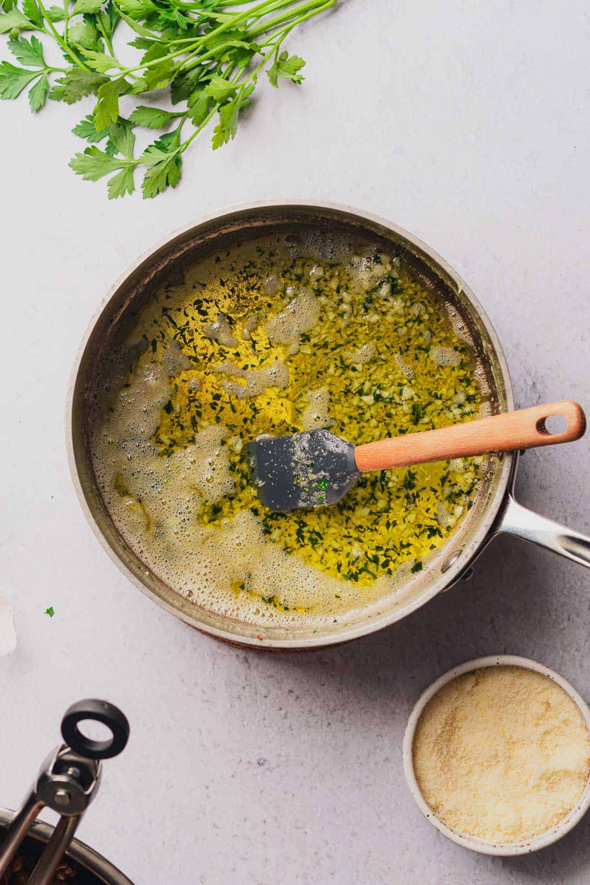 cooked buttery garlic sauce in a pan with parsley