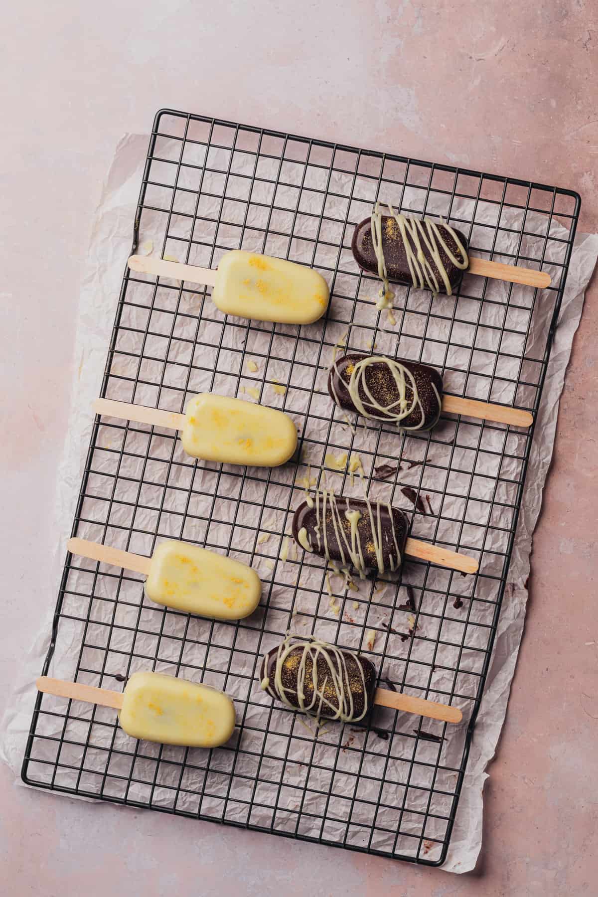 white chocolate and dark chocolate cakesicles with chocolate drizzle
