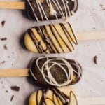 white chocolate and dark chocolate gluten free and keto cakesicles with drizzle and edible gold glitter