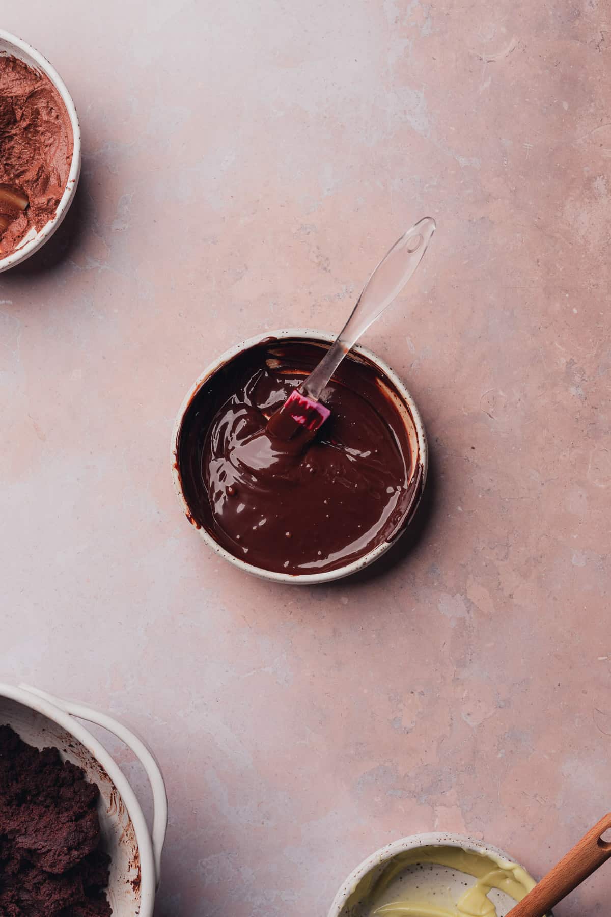 melted dark chocolate chips in a bowl with a rubber spatula