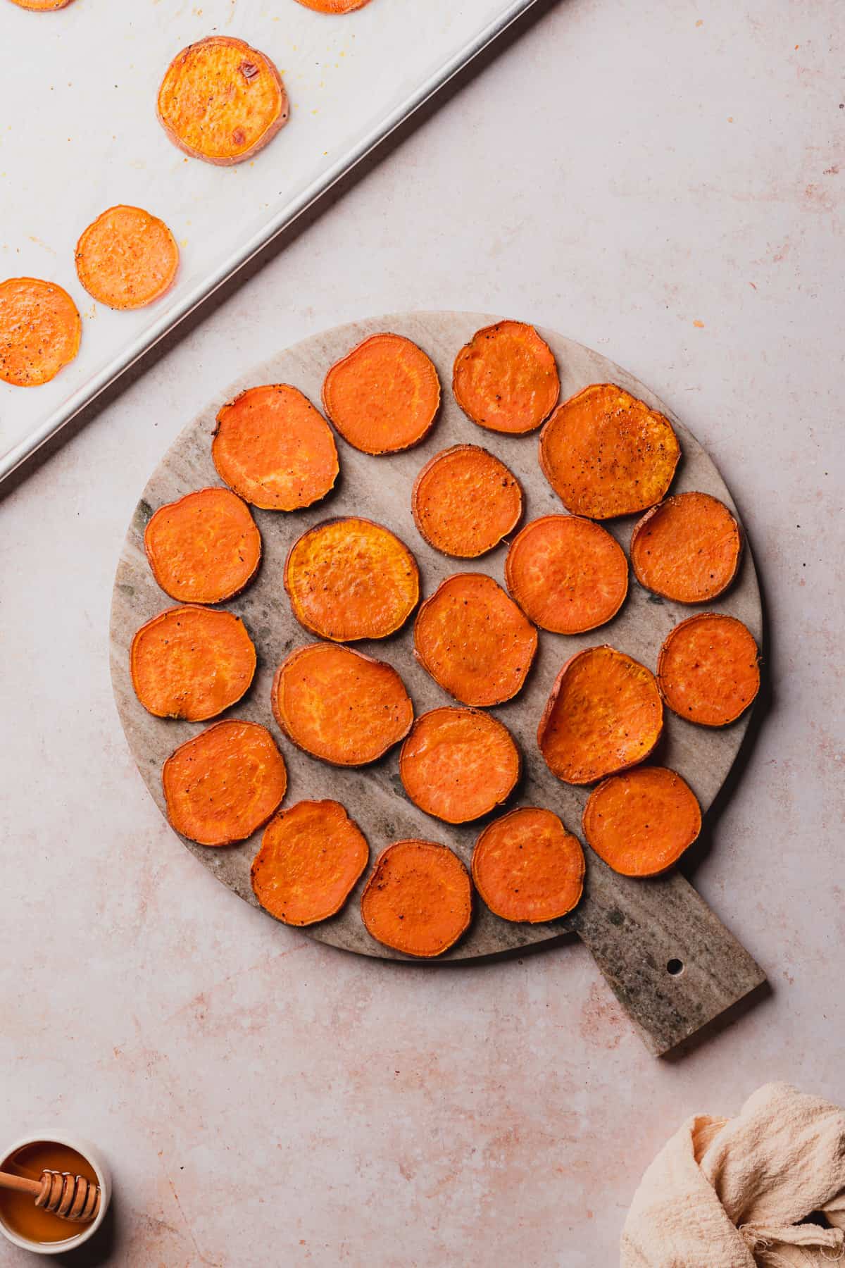 cooked sweet potato rounds on a serving tray