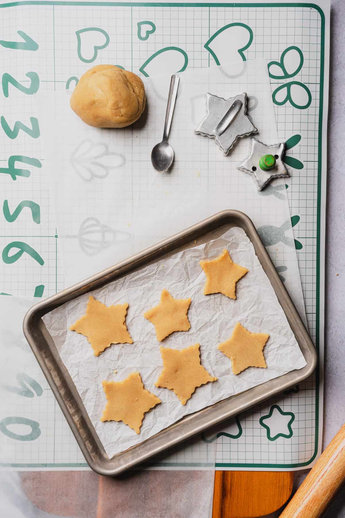 6 star cookie cutouts on a piece of parchment lined baking sheet 
