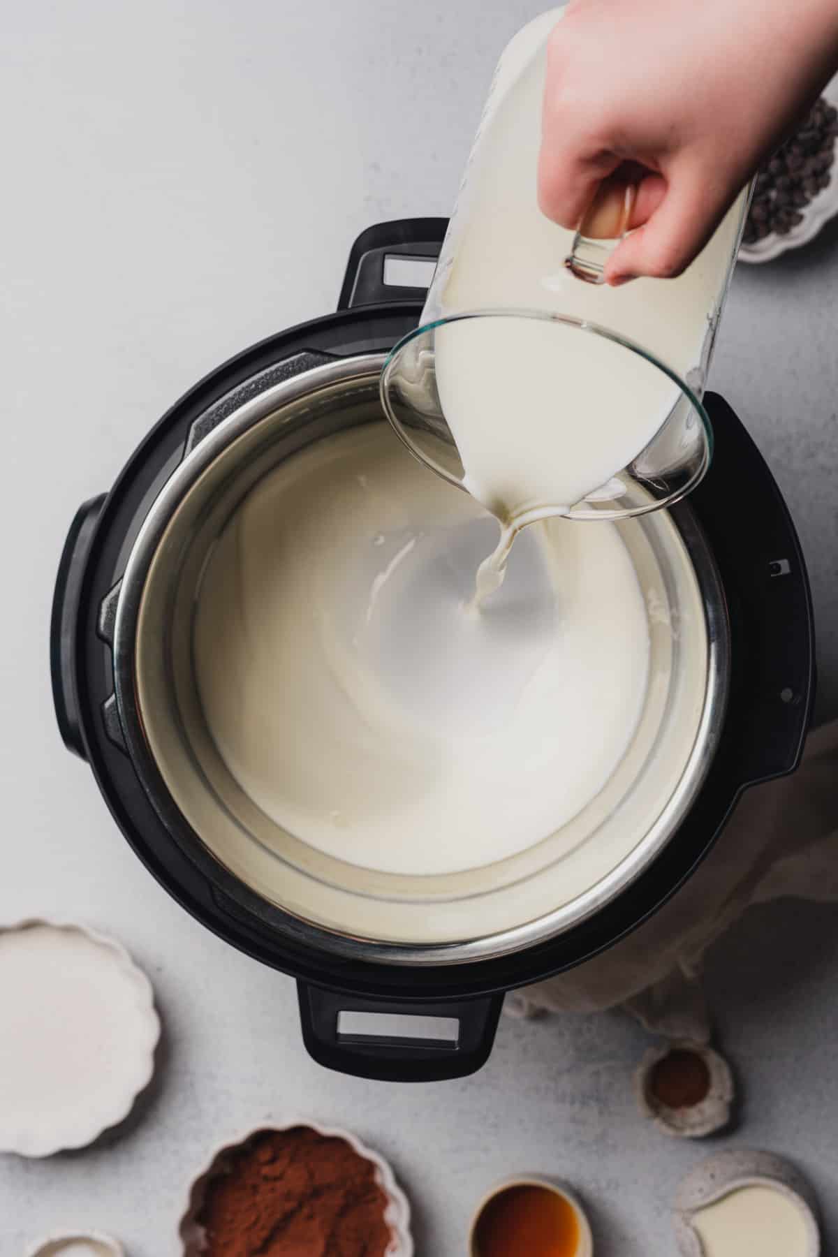 hand pouring milk into an instant pot