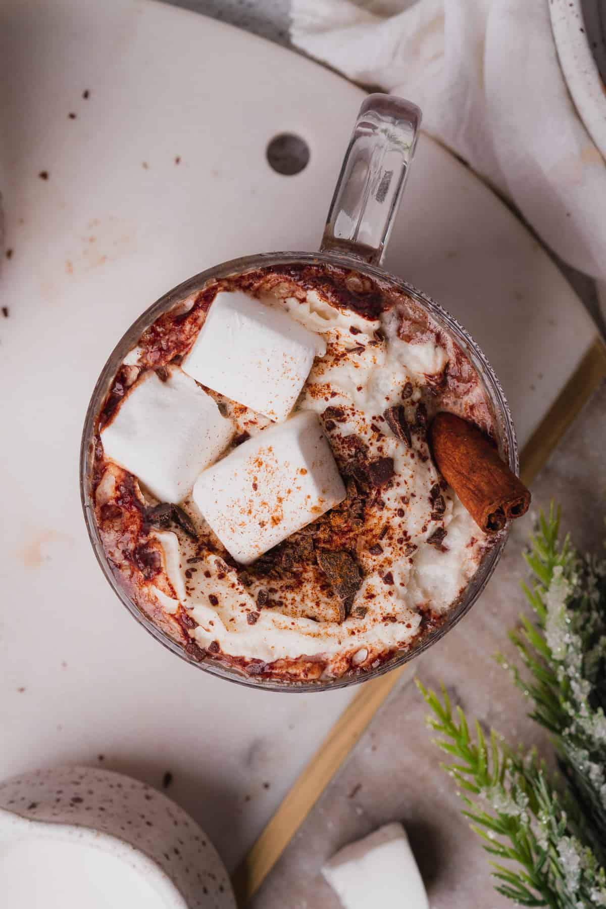 overhead shot of creamy instant pot chocolate with garland topped with marshmallows