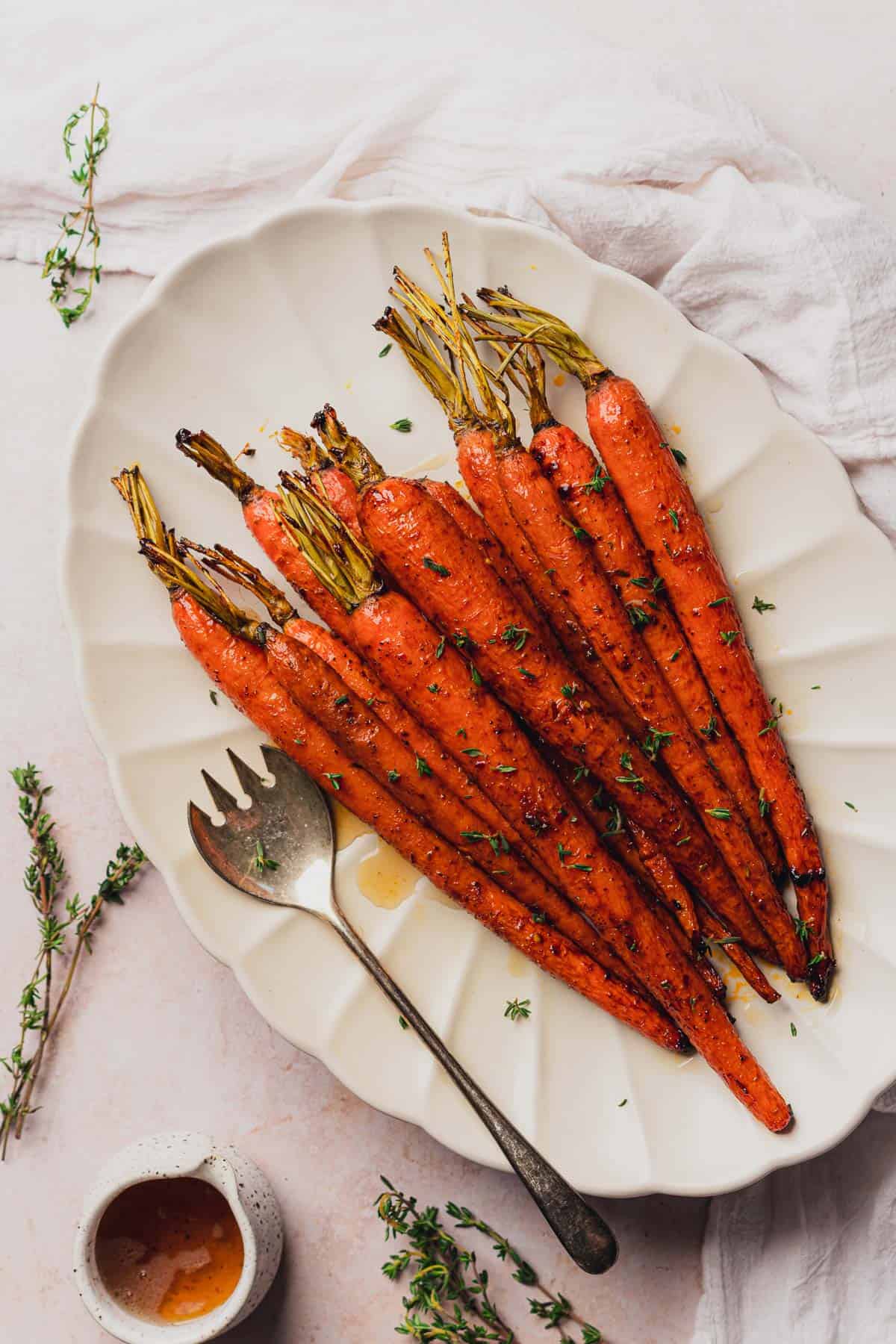 flat lay of keto glazed carrots with fresh thyme and sugar free maple syrup 