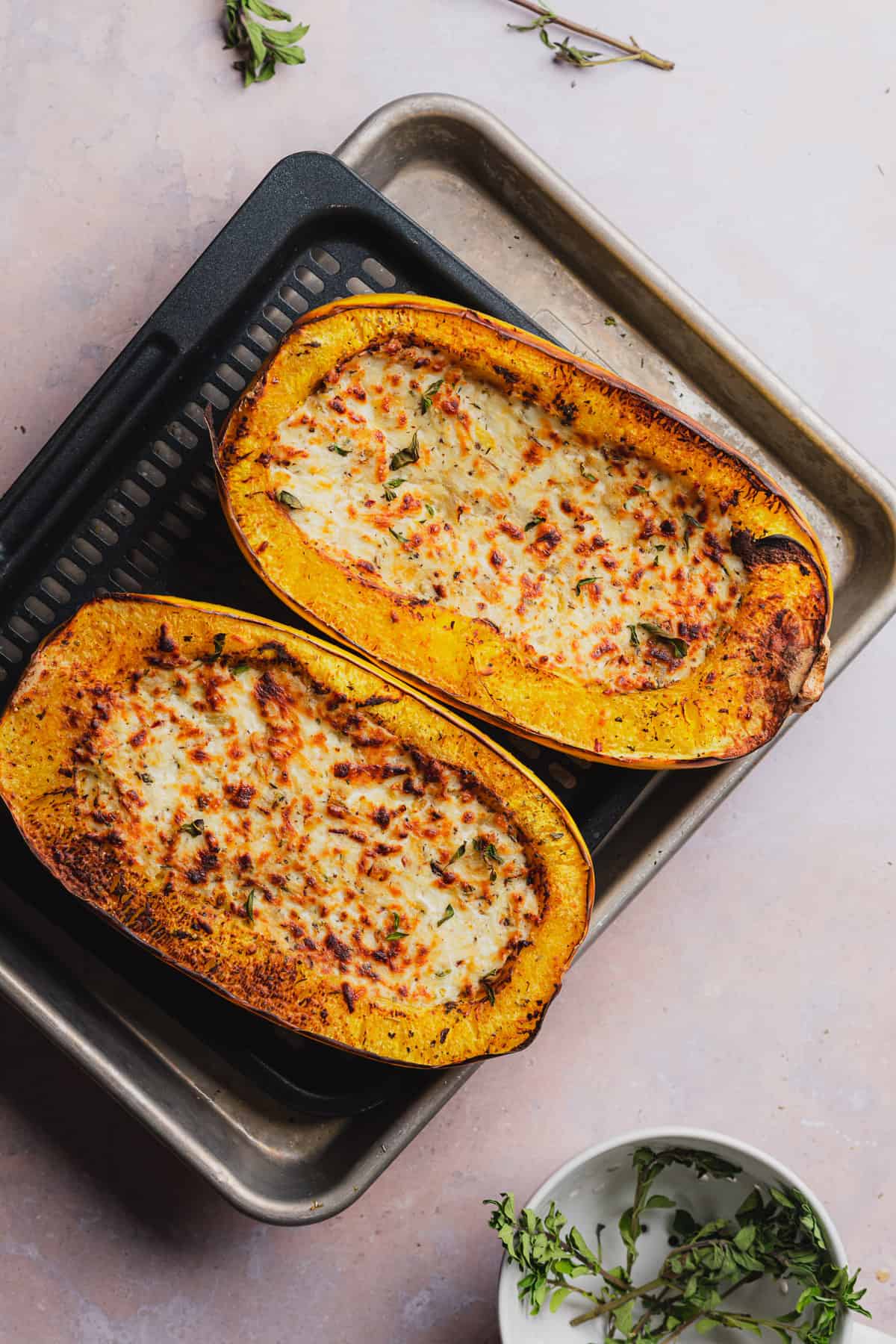 two halves of cooked air fryer spaghetti squash with cheese