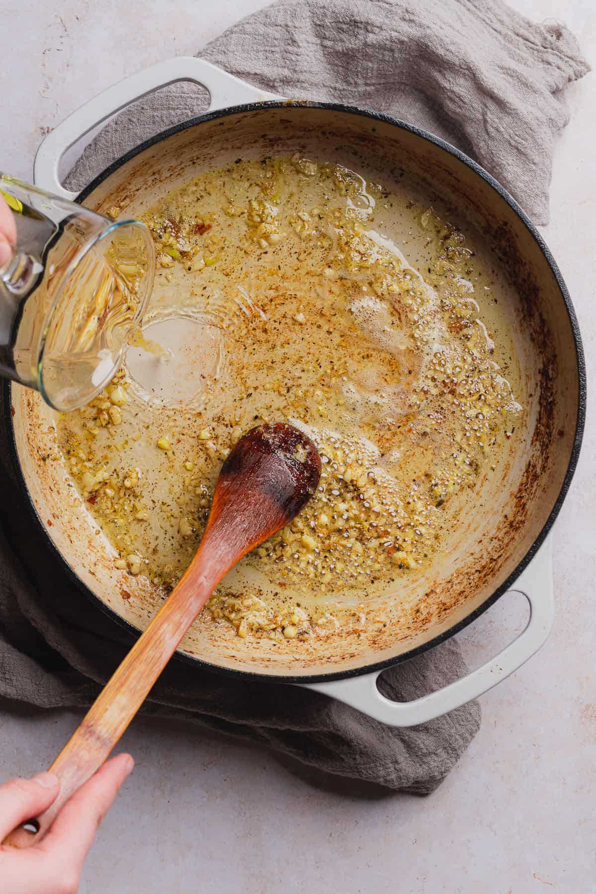 garlic and seasonings in a pan with white wine sauce