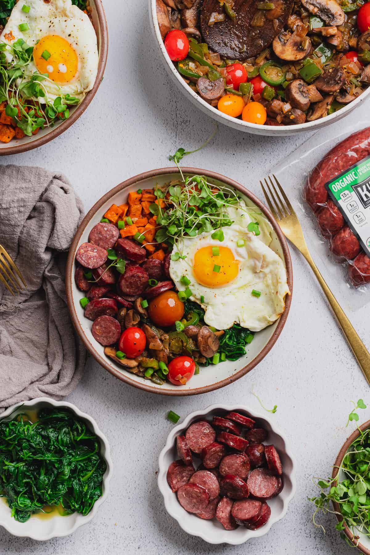 power macro bowls with smoked sausage, a fried egg and veggies