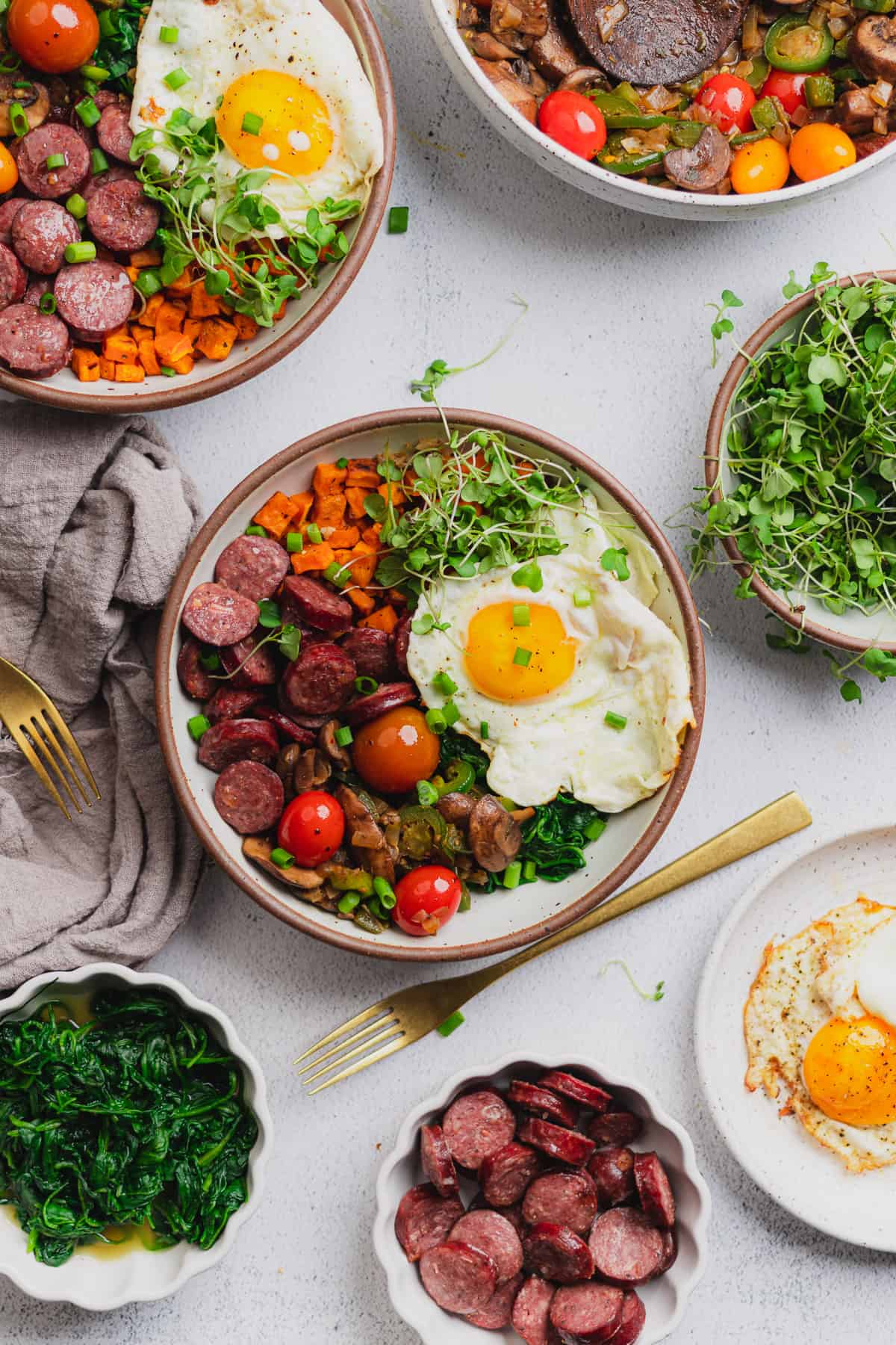 scene of an energy bowl made with smoked sausage, veggies and a fried egg