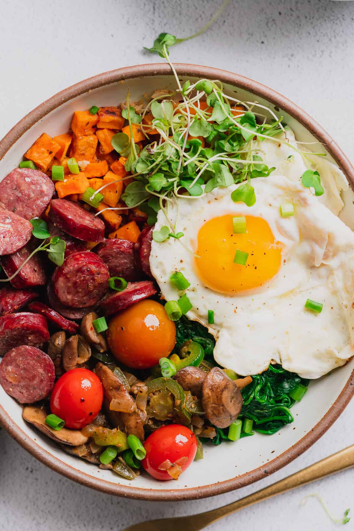 delicious energy bowl recipe with smoked sausage, veggies, and a fried egg