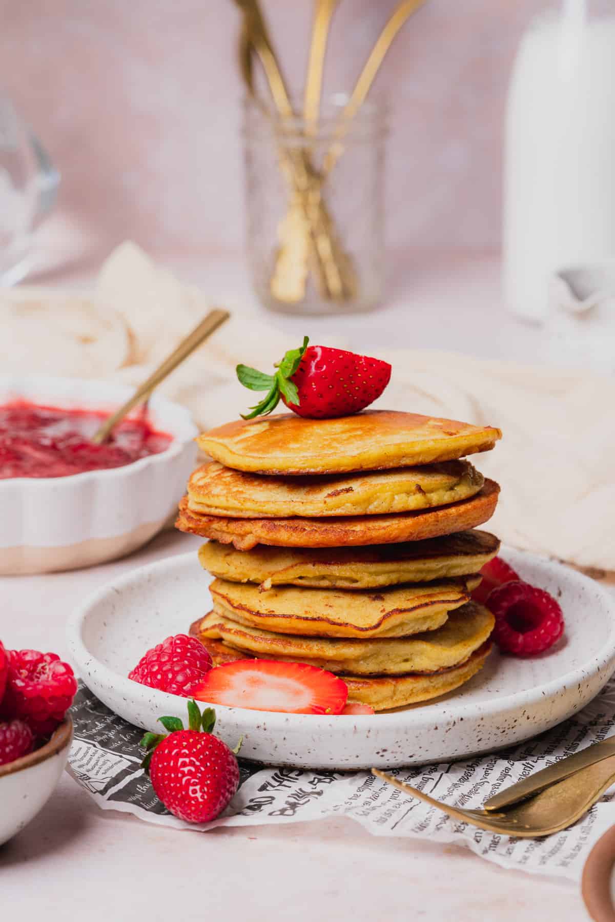 stack of keto coconut flour pancakes topped with berries 