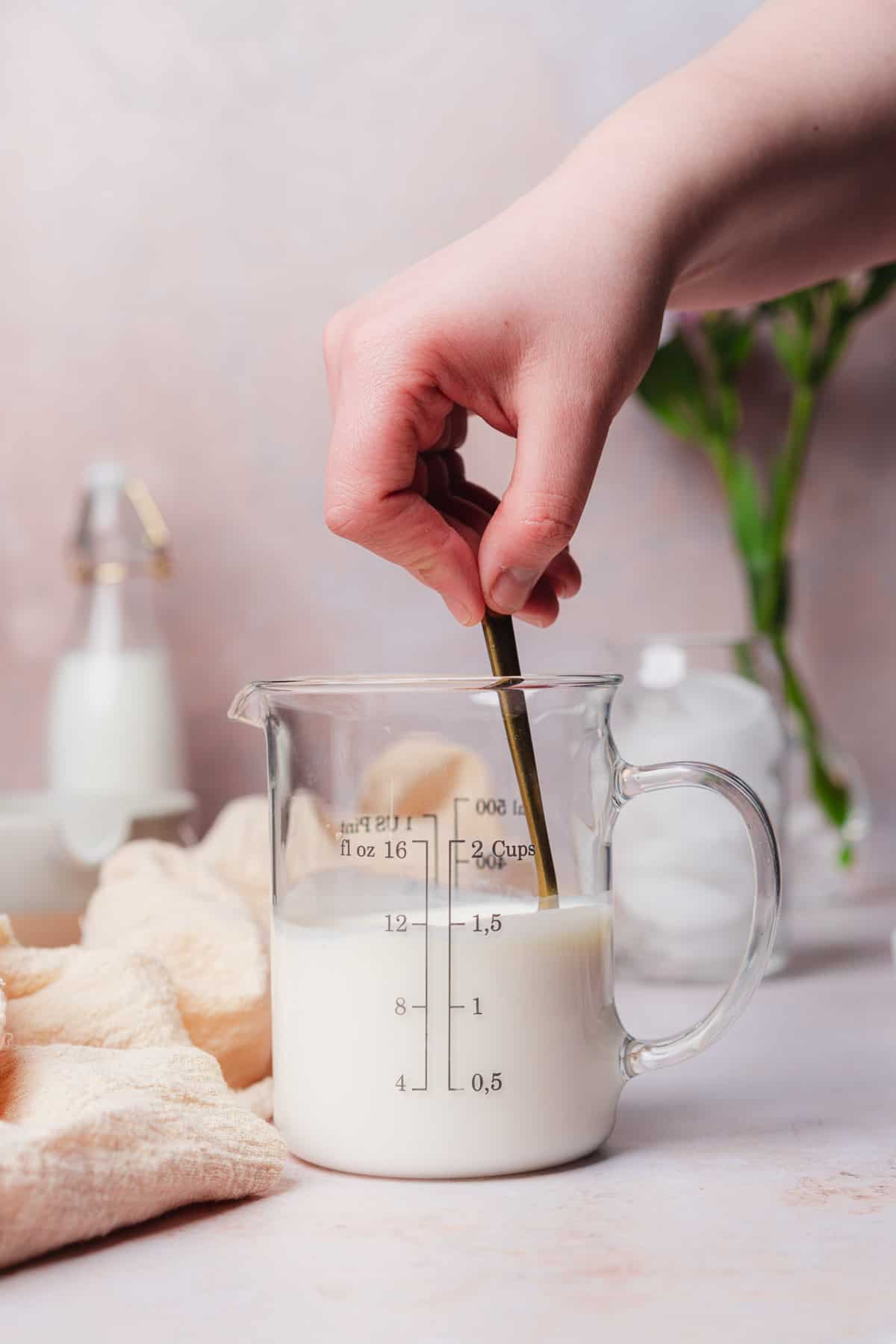 stirring vanilla extract into a beaker with milk