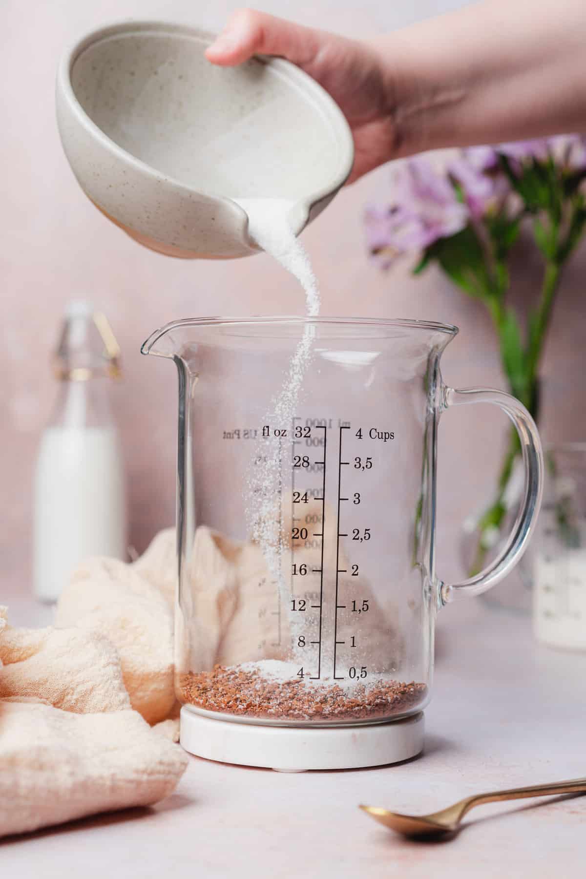 pouring granular sweetener into a glass jar