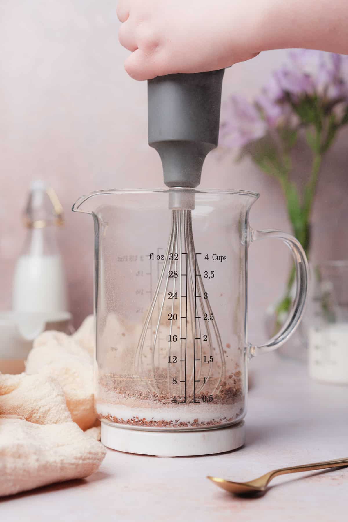 whisking instant coffee, sweetener, salt and cinnamon in a glass beaker